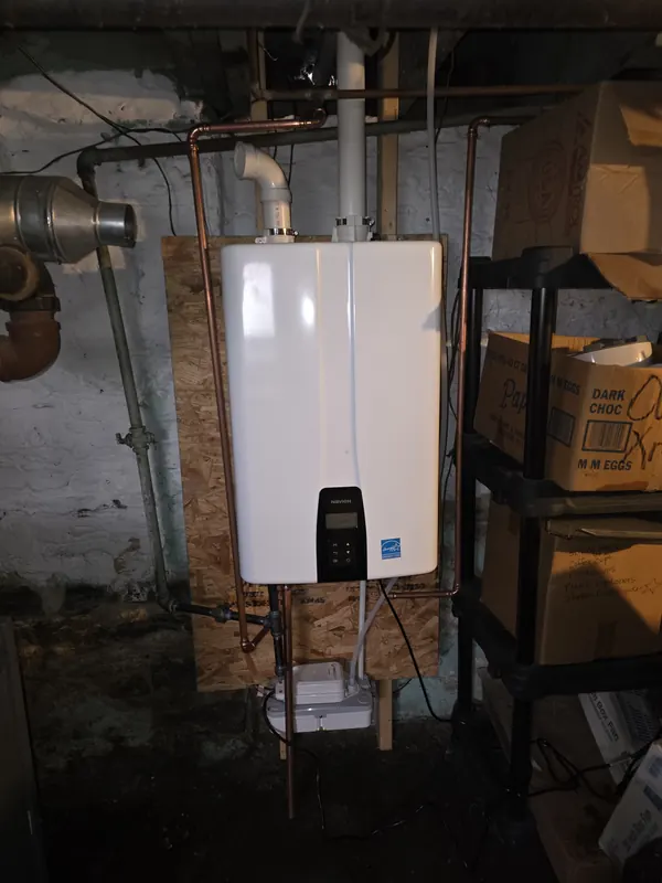 New Navien tankless water heater mounted in the same basement