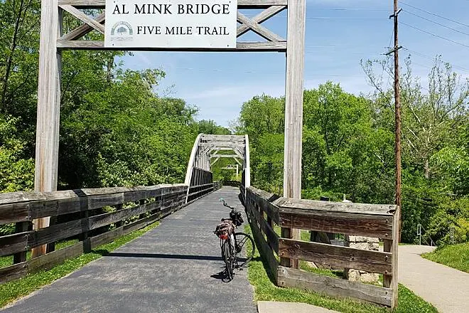 Al Mink Bridge on the Five Mile Trail, a wooden trail bridge with a bicycle parked on the path