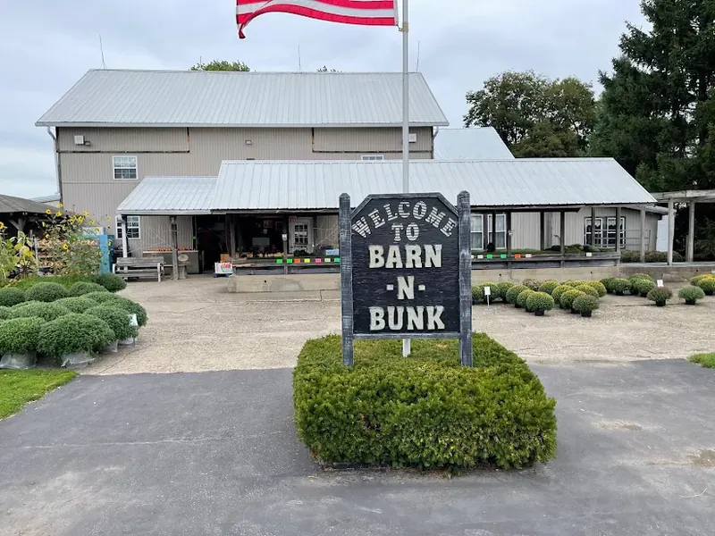 Welcome to Barn-N-Bunk sign in front of a farm market building in Trenton