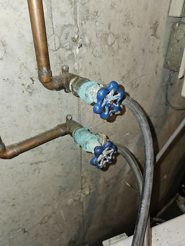 Corroded washing machine hose valves before replacement