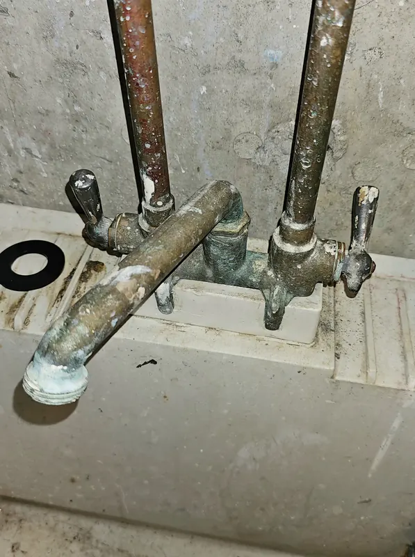 Old, corroded laundry tub faucet before replacement