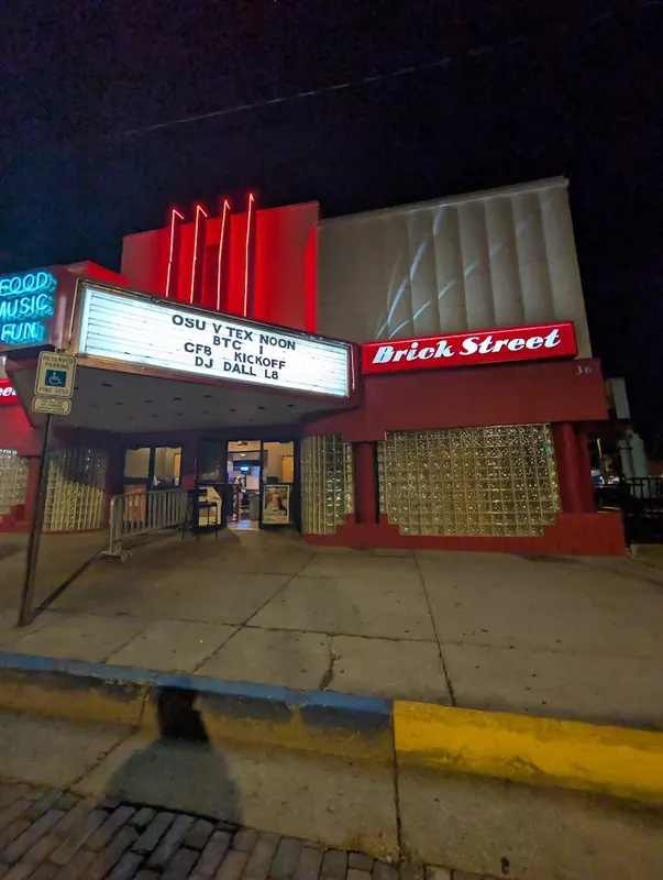 Brick Street building with a lit marquee in Uptown Oxford at night