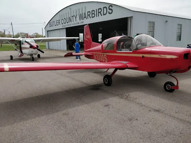 Red small plane parked outside the Butler County Warbirds hangar in Middletown