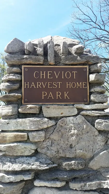 Stone pillar with a bronze plaque reading Cheviot Harvest Home Park