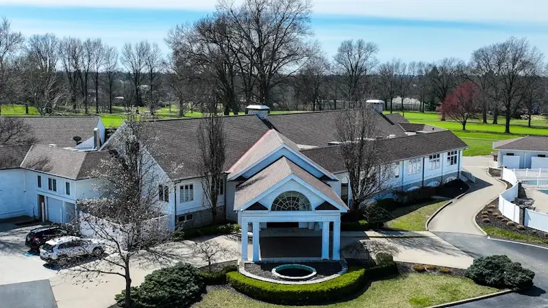 Aerial view of a clubhouse and golf course in North College Hill