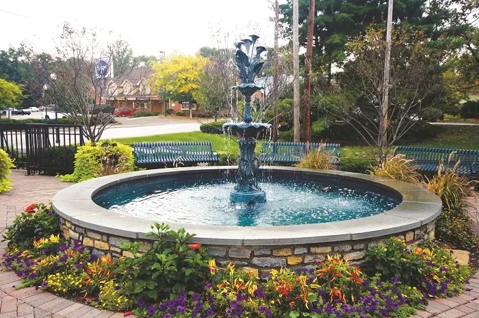 Decorative fountain surrounded by flowers and benches in Madeira