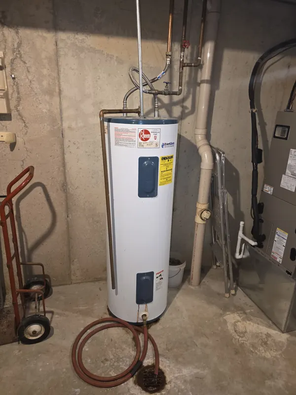 Rheem electric tank water heater in a basement