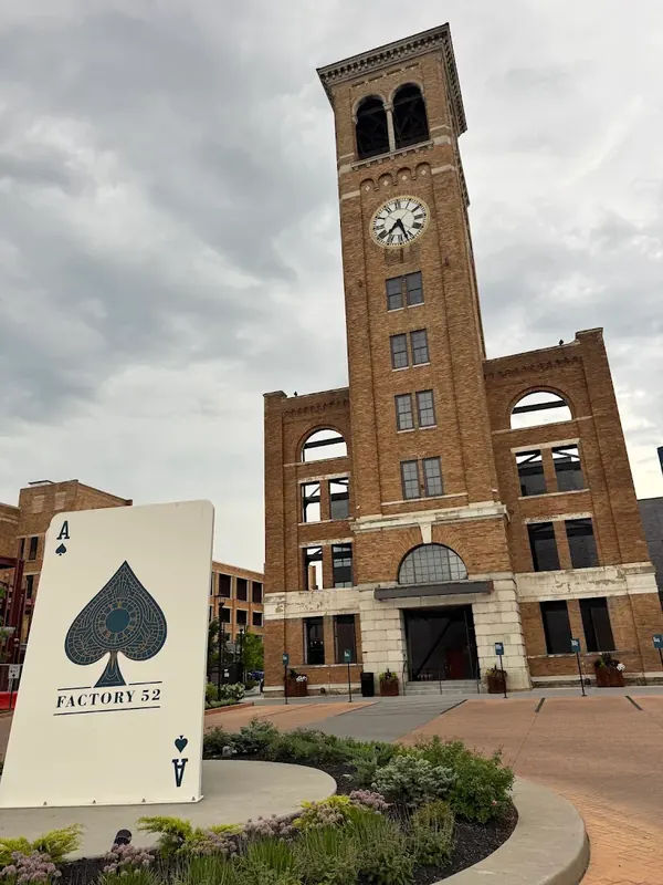 Factory 52 brick clock tower with a giant ace of spades card sculpture in Norwood