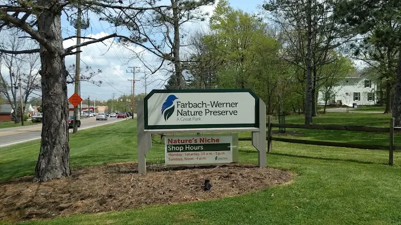 Farbach-Werner Nature Preserve sign on a grassy lawn under tall trees