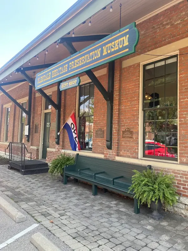 Glendale Heritage Preservation Museum storefront in a brick building with a green bench