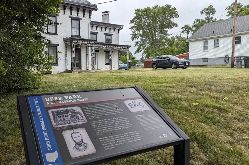 John Hunt Morgan Heritage Trail marker titled Deer Park: A Courageous Bluff in front of a white historic house