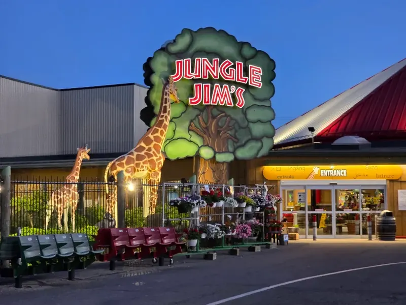 Jungle Jim's International Market entrance at dusk with giraffe statues in Fairfield