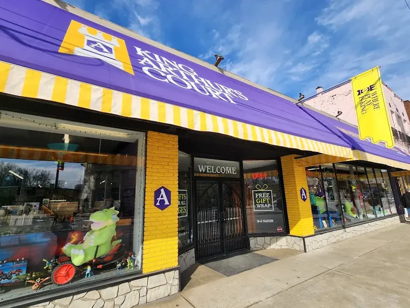 Purple and yellow awning of King Arthur's Court toy store on Madison Road in Oakley