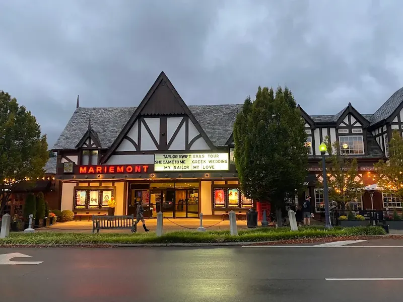 Tudor-style Mariemont Theatre with its lit marquee at dusk