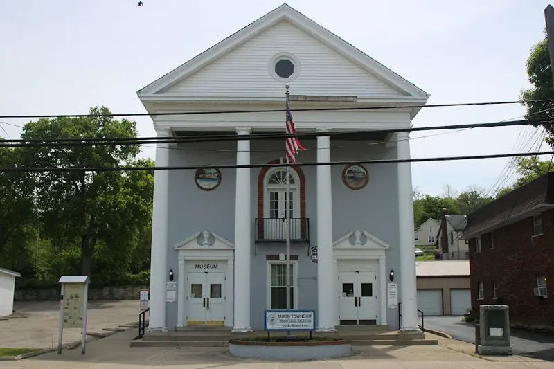 Miami Township Town Hall, a white-columned building with an American flag out front