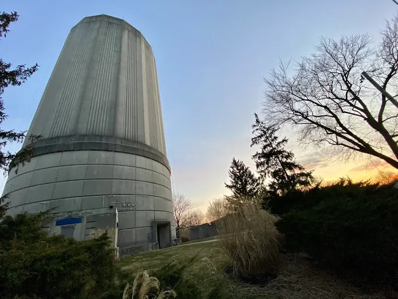 Mount Washington water tower at sunset with bare trees