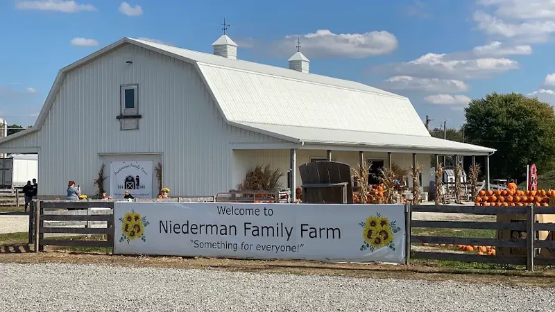 White barn and welcome sign at Niederman Family Farm in Liberty Township