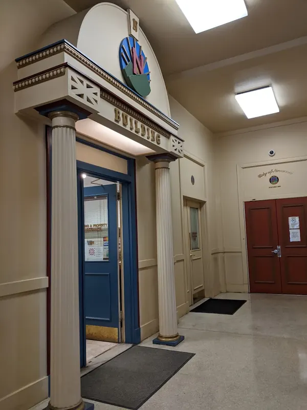 Interior entrance of the Norwood Municipal Building with columns and a blue door
