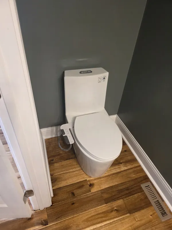 New one-piece toilet installed in a bathroom