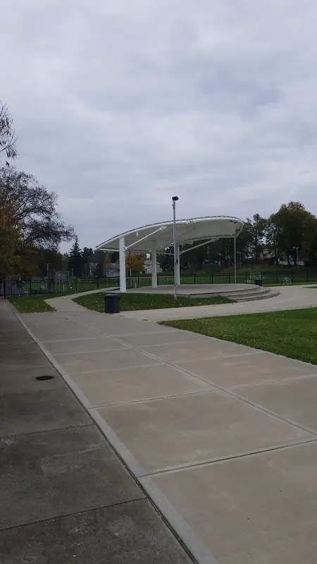 White canopy bandstand at the end of a park walkway in Mount Healthy
