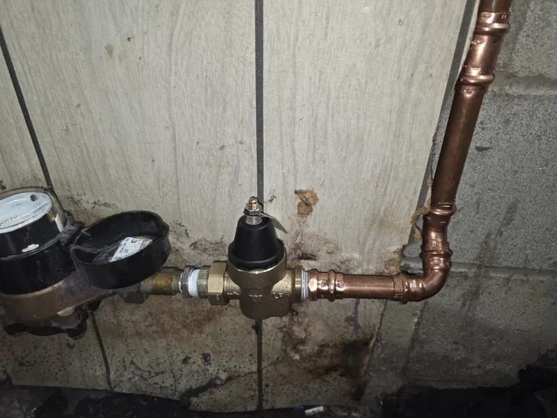 New pressure reducing valve installed after the water meter with copper piping