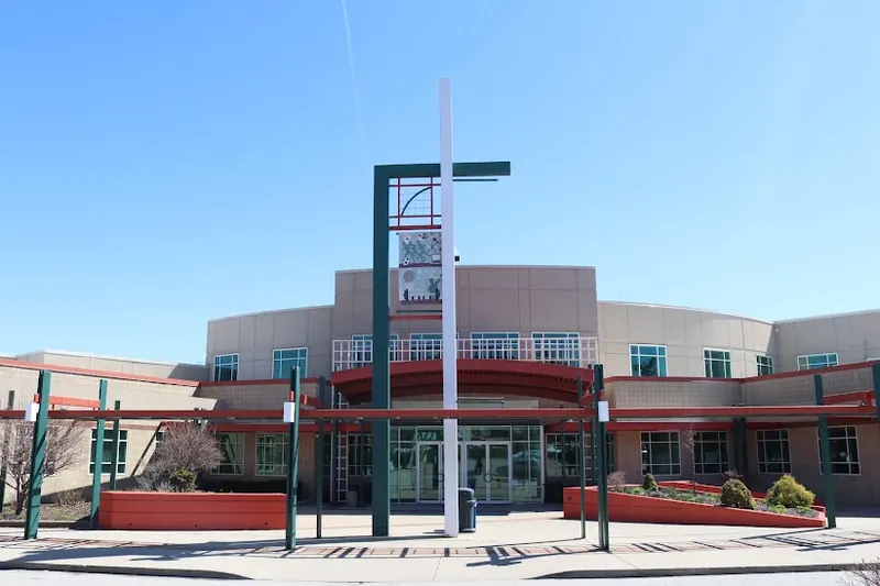 Springdale Community Center entrance with a tall white and green tower on a sunny day