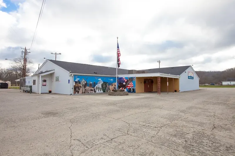 White building with a veterans mural and an American flag in Harrison