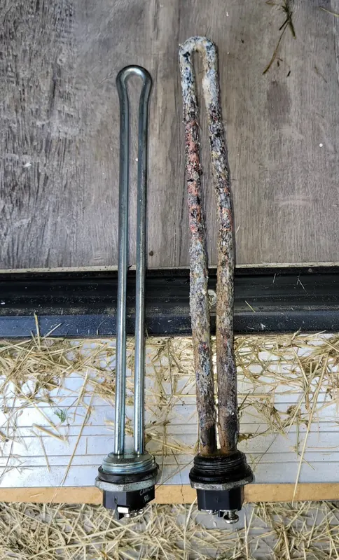 New electric water heater element next to a corroded, scale-covered old element