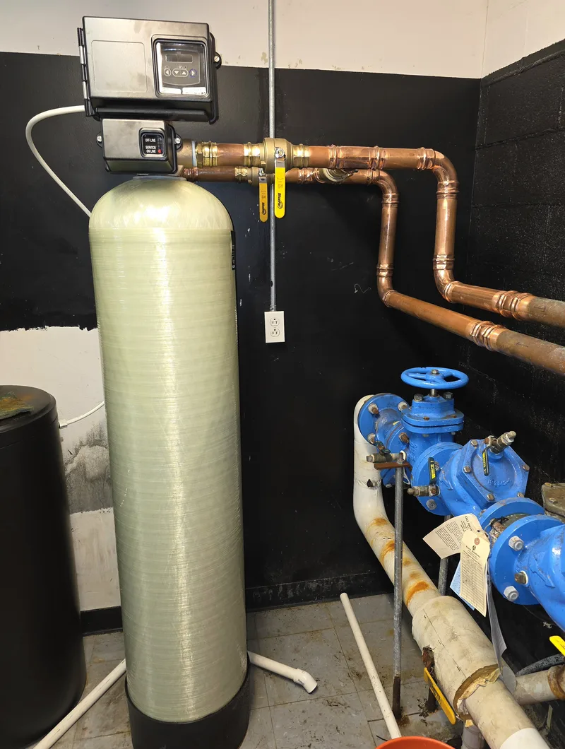Water softener tank and control valve connected with new copper piping