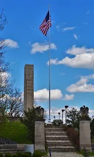 William Henry Harrison Tomb obelisk with an American flag above a stone stairway