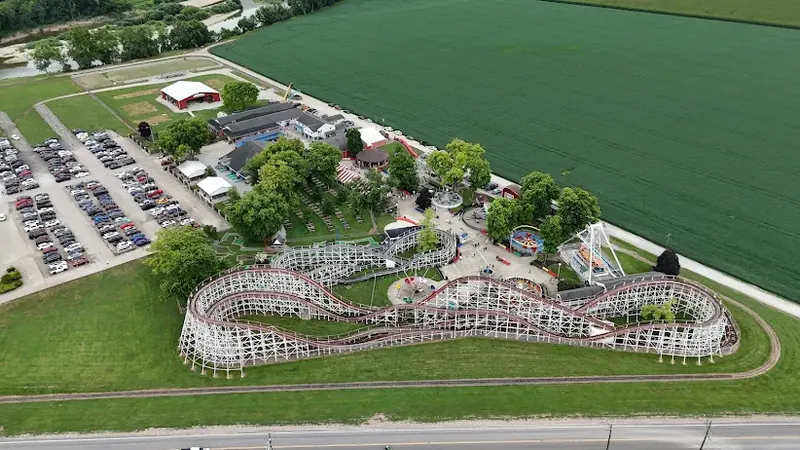 Aerial view of a wooden roller coaster beside farm fields in Ross Township